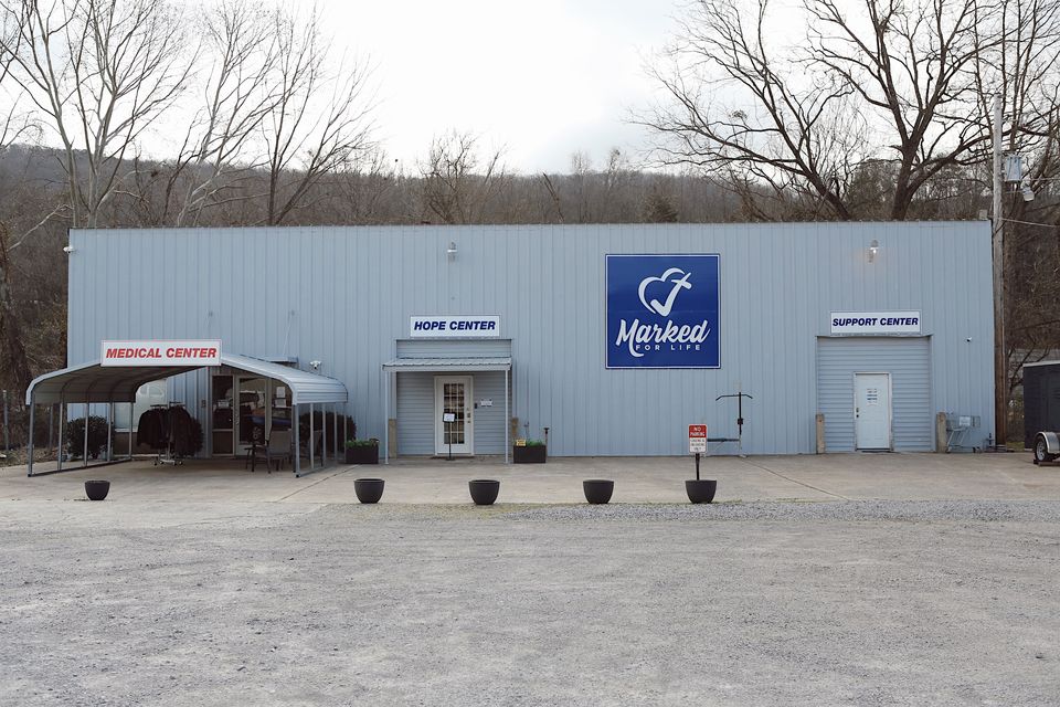 The Marked For Life campus at 917 Godfrey Ave S: one metal building with Medical Center, Hope Center, and Support Center entrances.